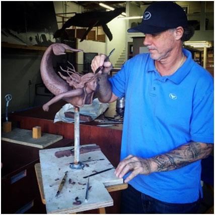 Wyland working on bronze sculpture.